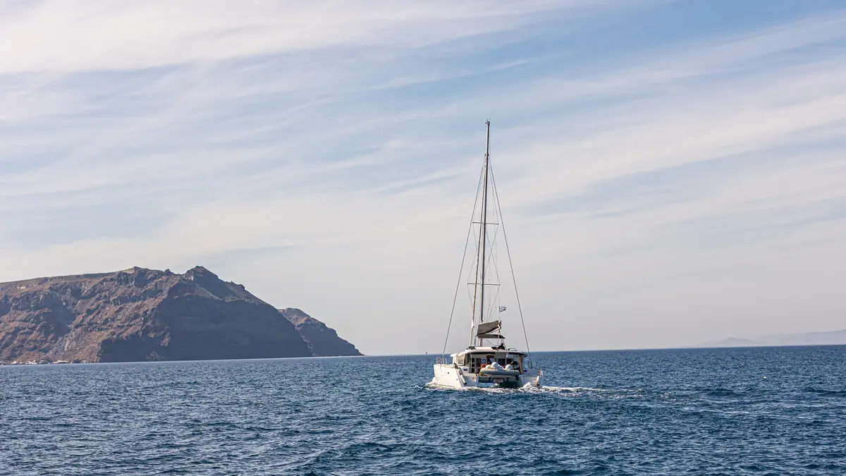 Four times of day on the Santorini caldera — morning to dusk bands