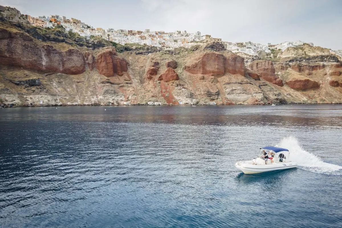 Ammoudi Bay and Oia seen from the water on the caldera loop