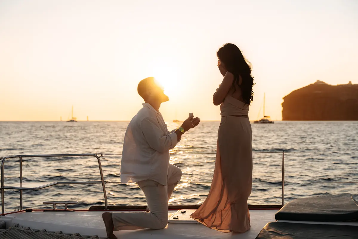A marriage proposal on the foredeck at sunset during a private charter