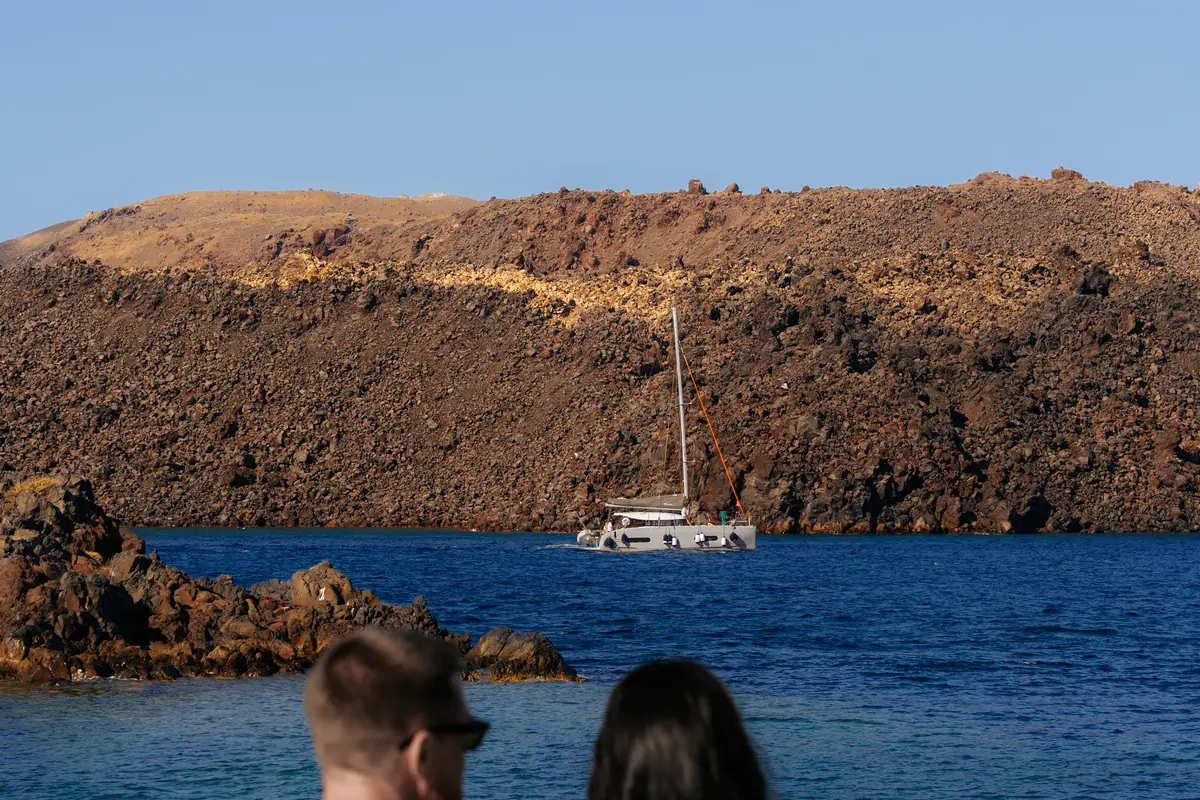 Our catamaran beneath the volcanic cliffs of the Santorini caldera