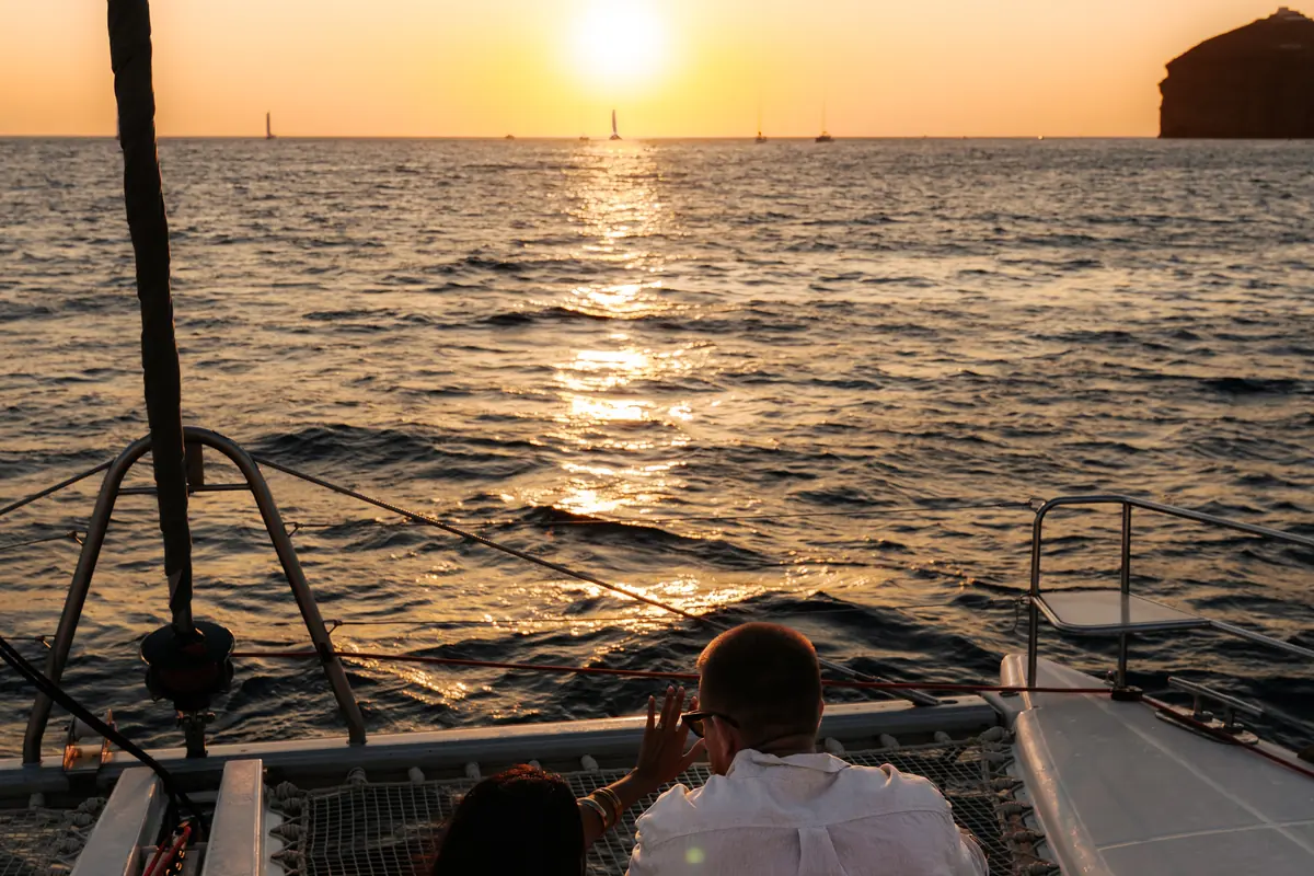 Sailing home under a violet dusk sky off Santorini