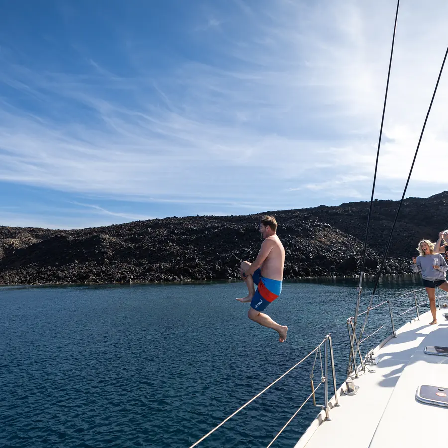 Leaping off the catamaran at the Nea Kameni volcano swim stop