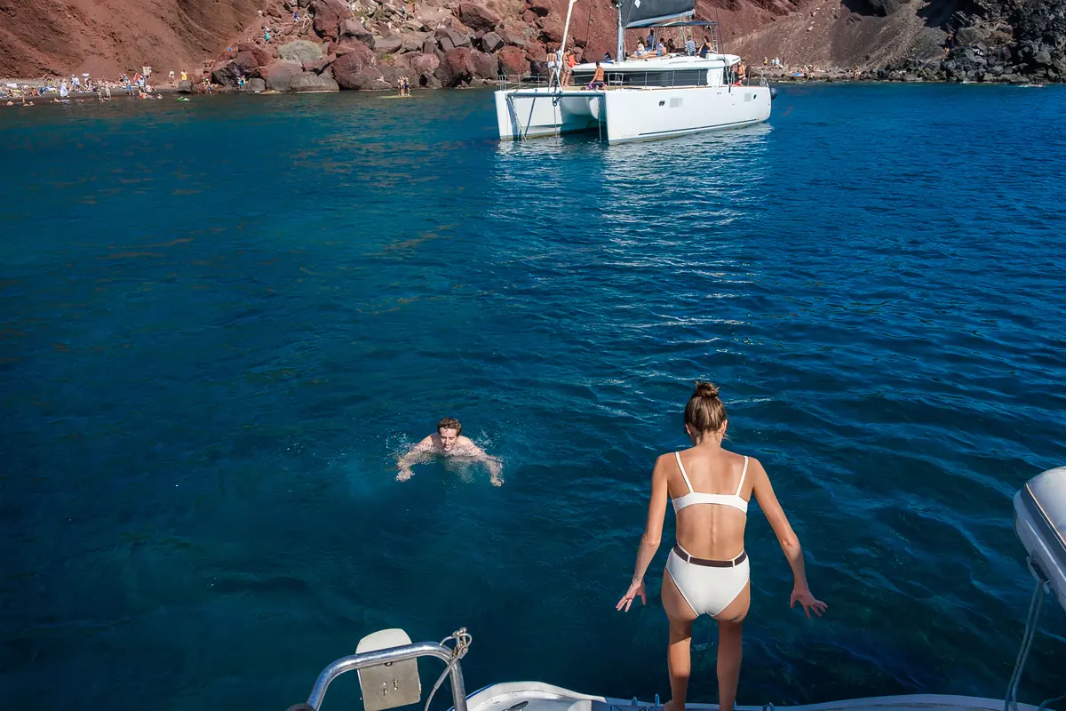 Swim stop below the red cliffs of Red Beach, Santorini