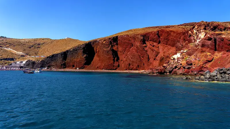 Red Beach Santorini — rust-red volcanic cliffs above turquoise sea