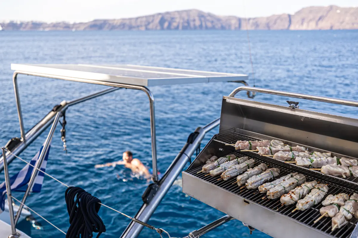 Freshly grilled BBQ skewers over charcoal on board the catamaran