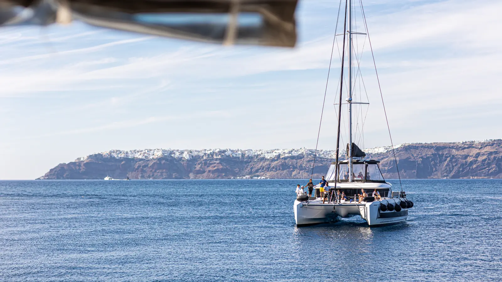 Our catamaran on the Santorini caldera cruise route beneath the cliffs below Oia